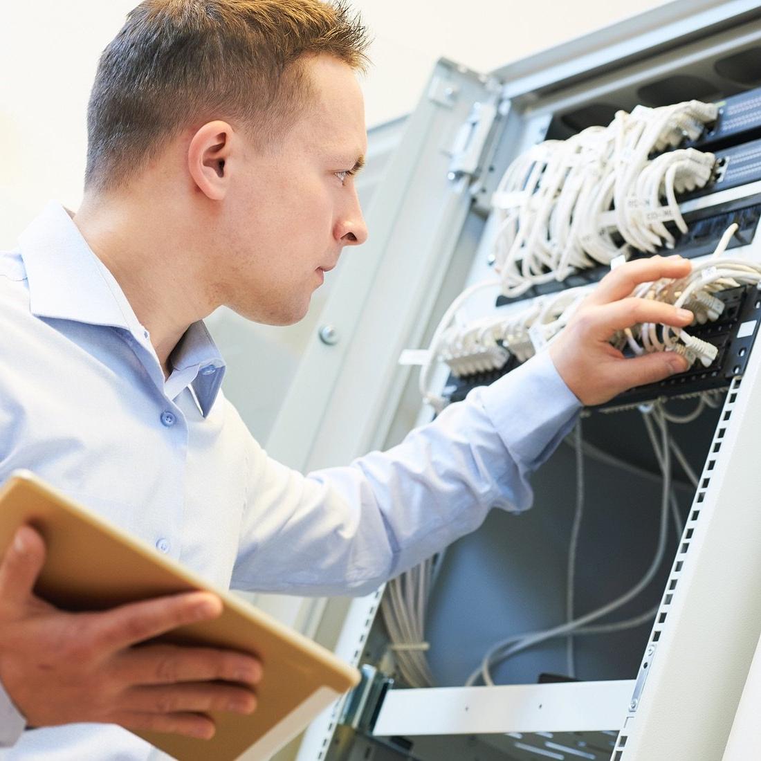 Person updating electrical equipment.